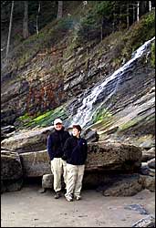 cliche image of young couple in front of waterfall